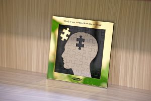 A picture of a brain puzzle with one piece missing and the missing piece is gold, symbolising how EMDR helps the brain reprocess trauma